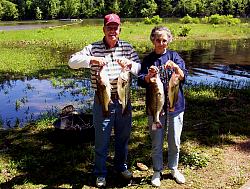 Elderly couple showing off their catch of largemouth bass